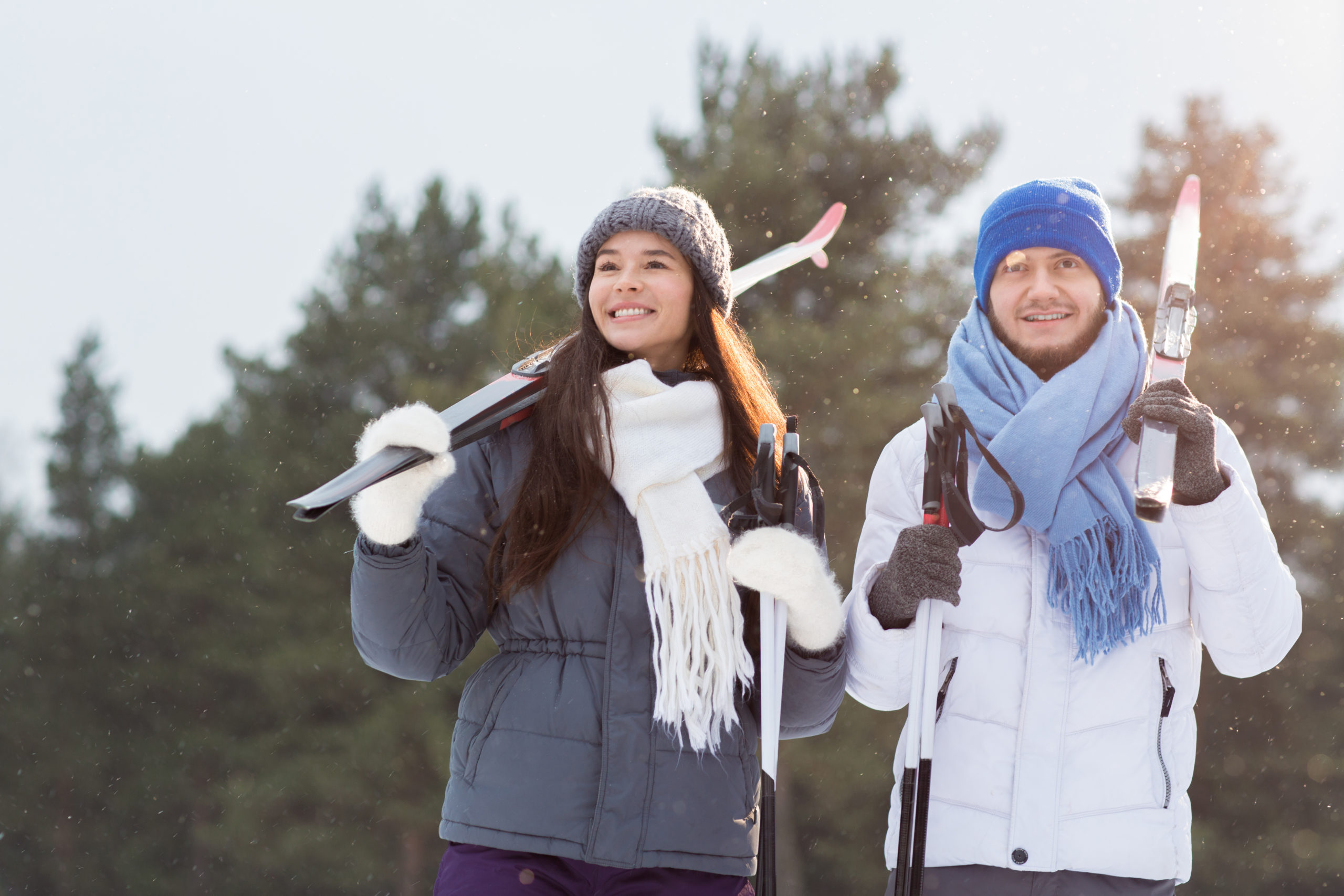 A man and woman with ski equipment